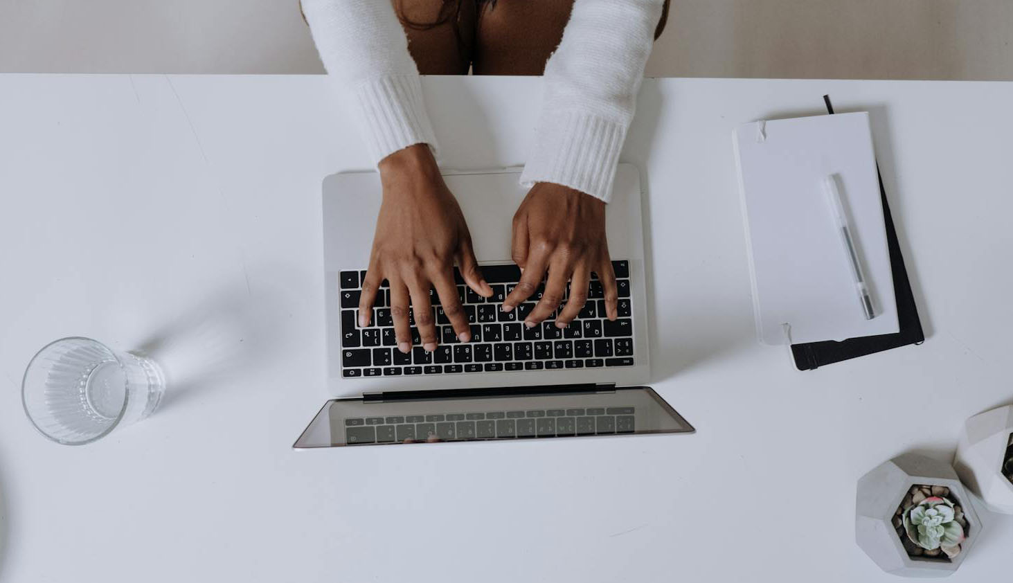 Mains d'une femme qui tapent sur le clavier d'un ordinateur
