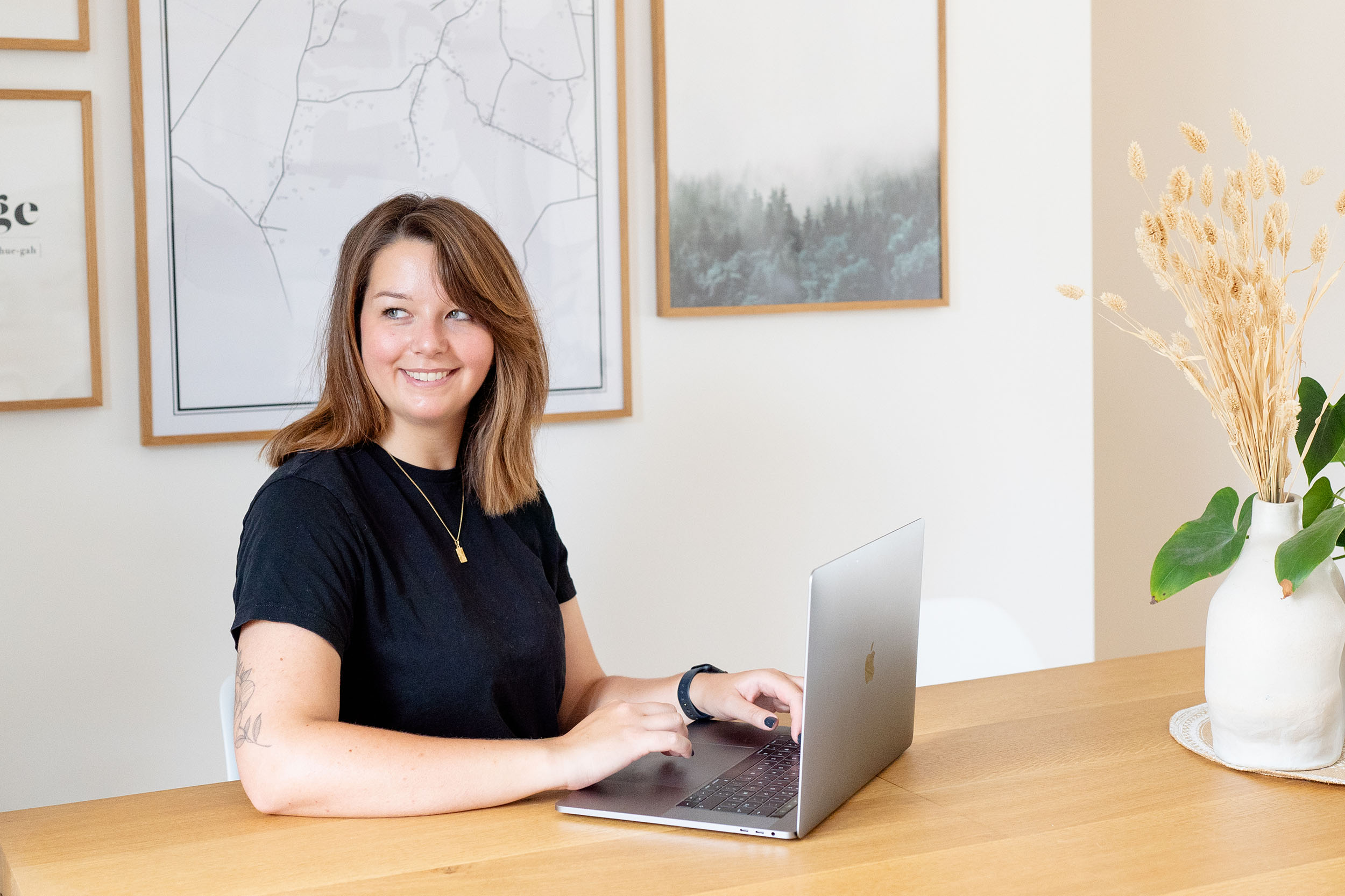 Femme assise à une table devant son ordinateur